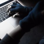 hacker typing on keyboard
