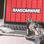laptop showing ransomware with money and locked drive
