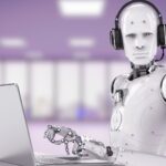 Robot wearing a headset and working on a laptop