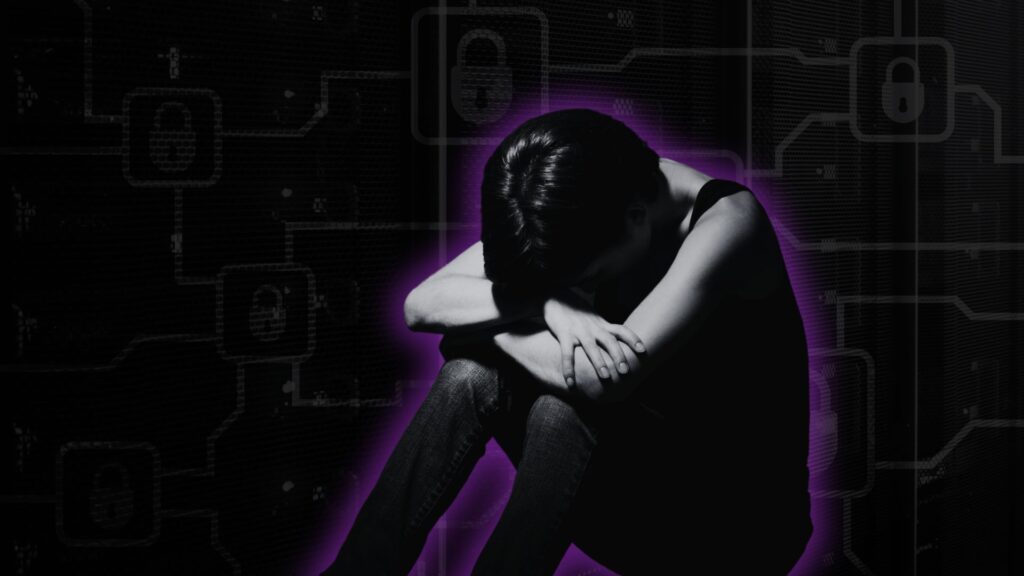 person holding head in lap in front of cyber background