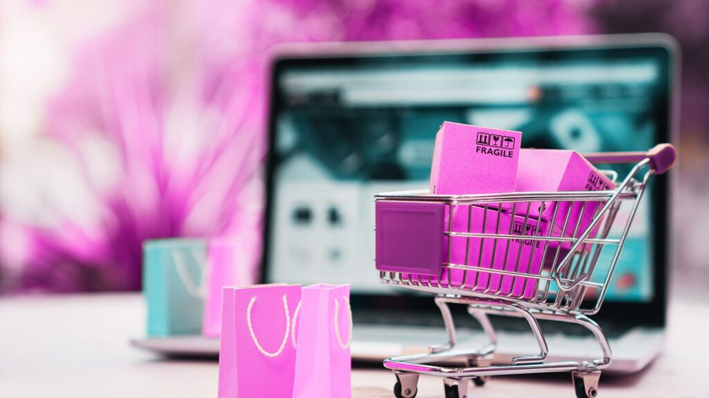 laptop and online shopping trolley cart, gift bags and delivery boxes