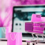 laptop and online shopping trolley cart, gift bags and delivery boxes