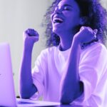 person in front of laptop excited about the cybersecurity wins for the weekend
