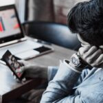 person scrolling on phone instead of working