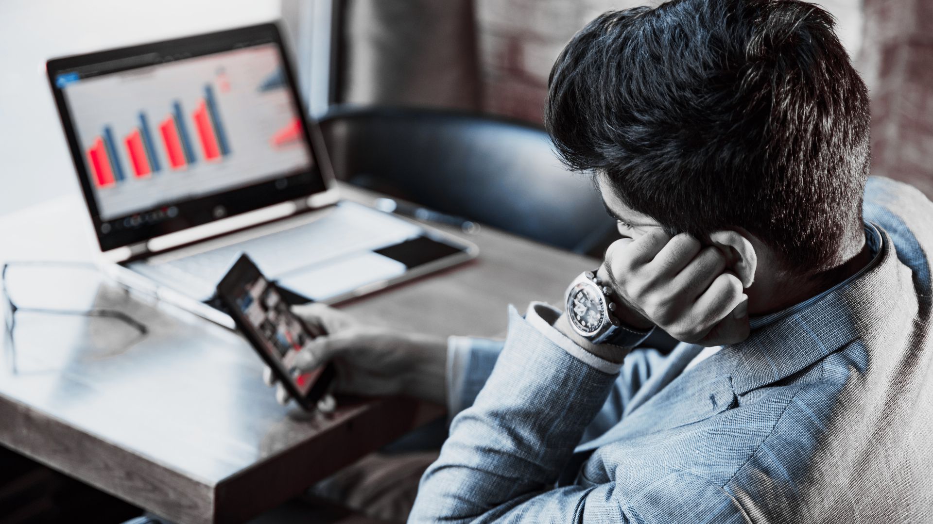 person scrolling on phone instead of working