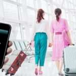 People in an airport and someone connecting to free Wi-Fi from their phone